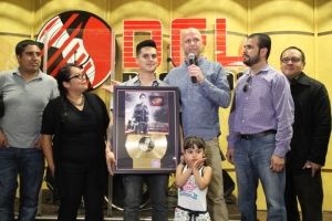 (L to R) Nigel Rubalcaba, Caro's marketing manager, Maria Castellon, Director of Product Management and Artist Relations, Del Records, artist Regulo Caro (with daughter), Steve Weatherby, VP Del Records presenting RIAA's Latin Gold Certification Plaque for Caro's 2011 "Musica, Polvora y Sangre," Juaquin Caro, Artist Manager, Justino Aguila, Director of Media Relation, Del Records. (Photo by: Fredwill Hernandez/THT)